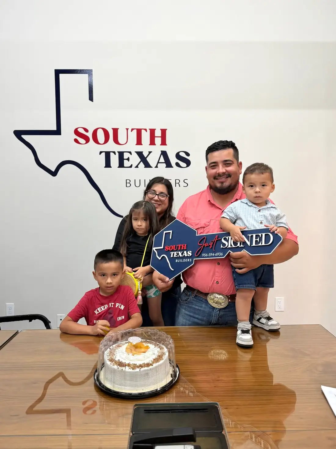 The Almanza family and their children holding the South Texas Builders key
