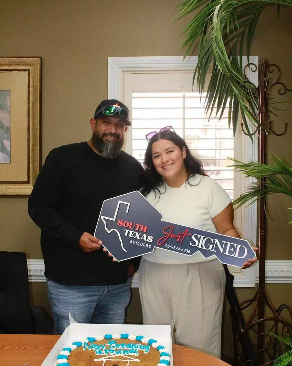 The Gamez family holding the commemorative key to their new home