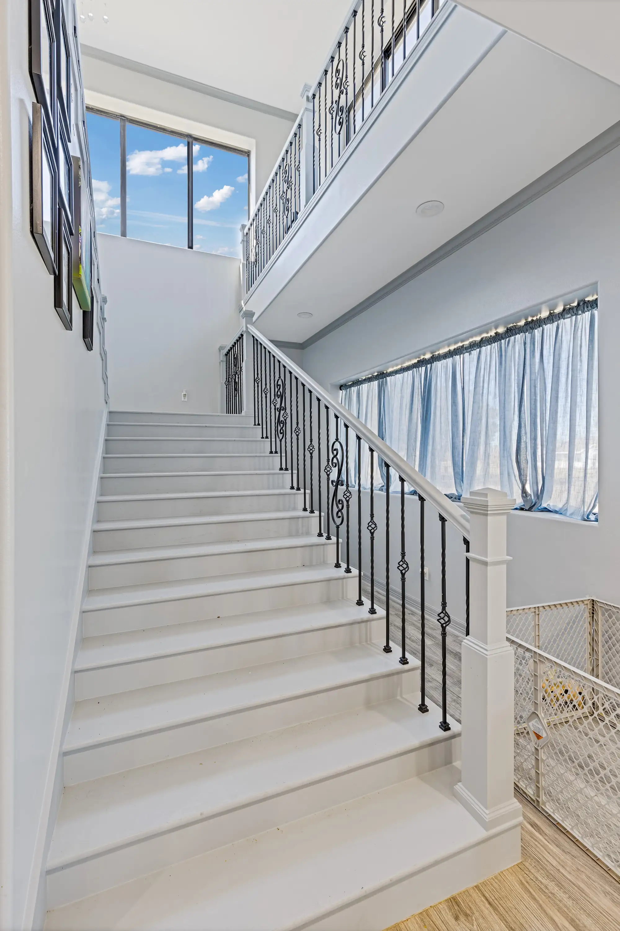 Ornamental iron stair rail rising to the second floor