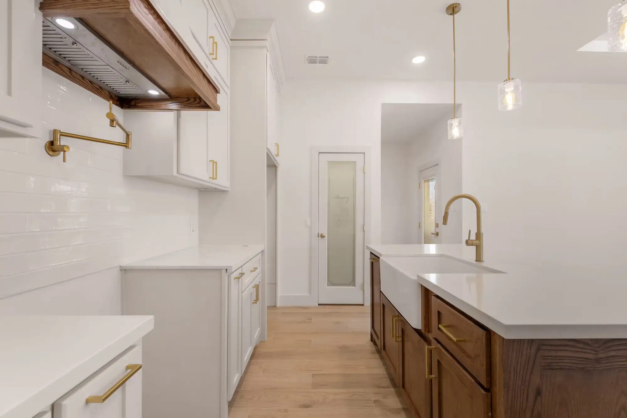 Service run with white subway tile, a reclaimed wood beam and glass pantry door