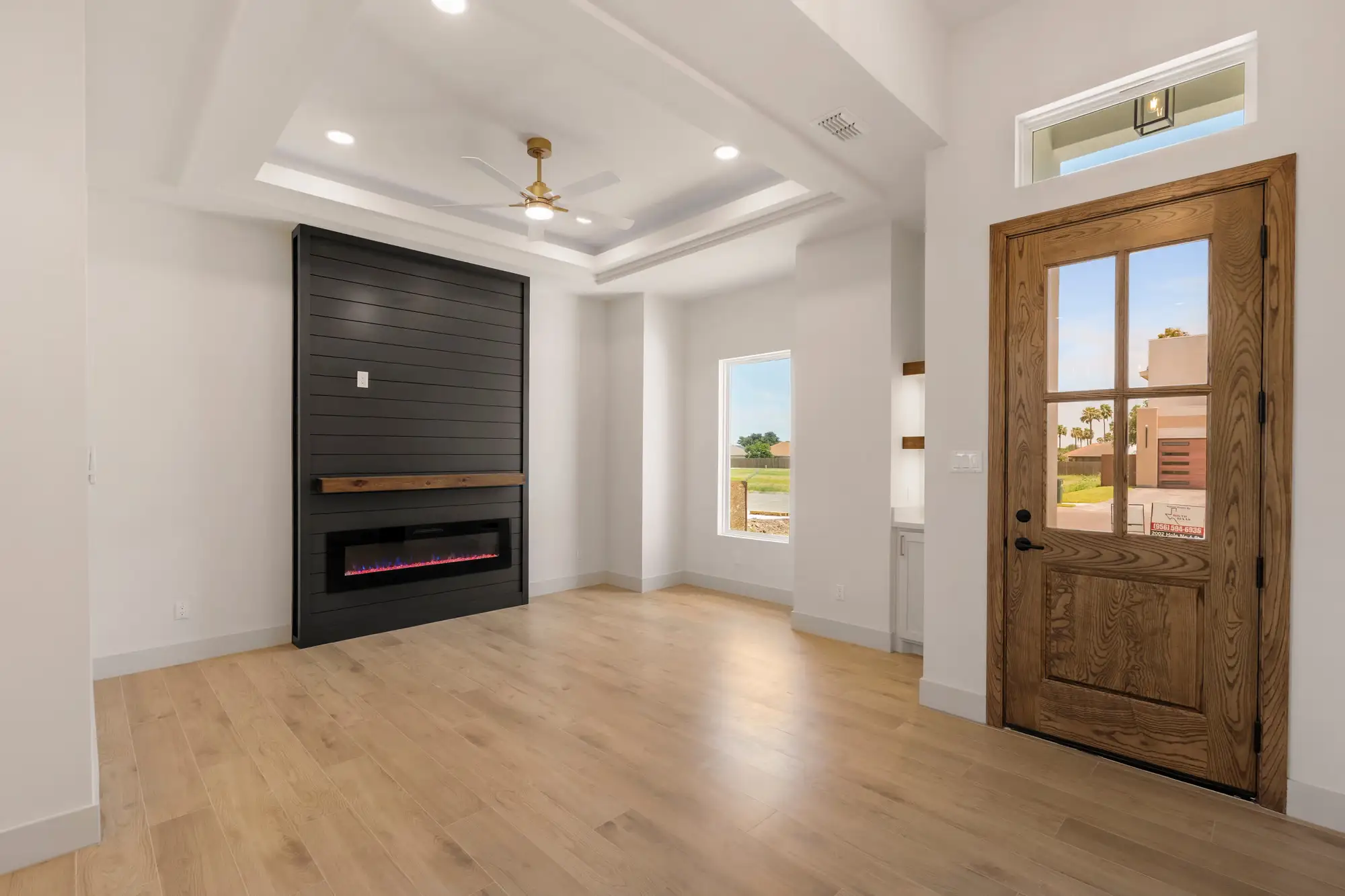 Front entry with a solid wood door and sidelight washing the foyer in daylight