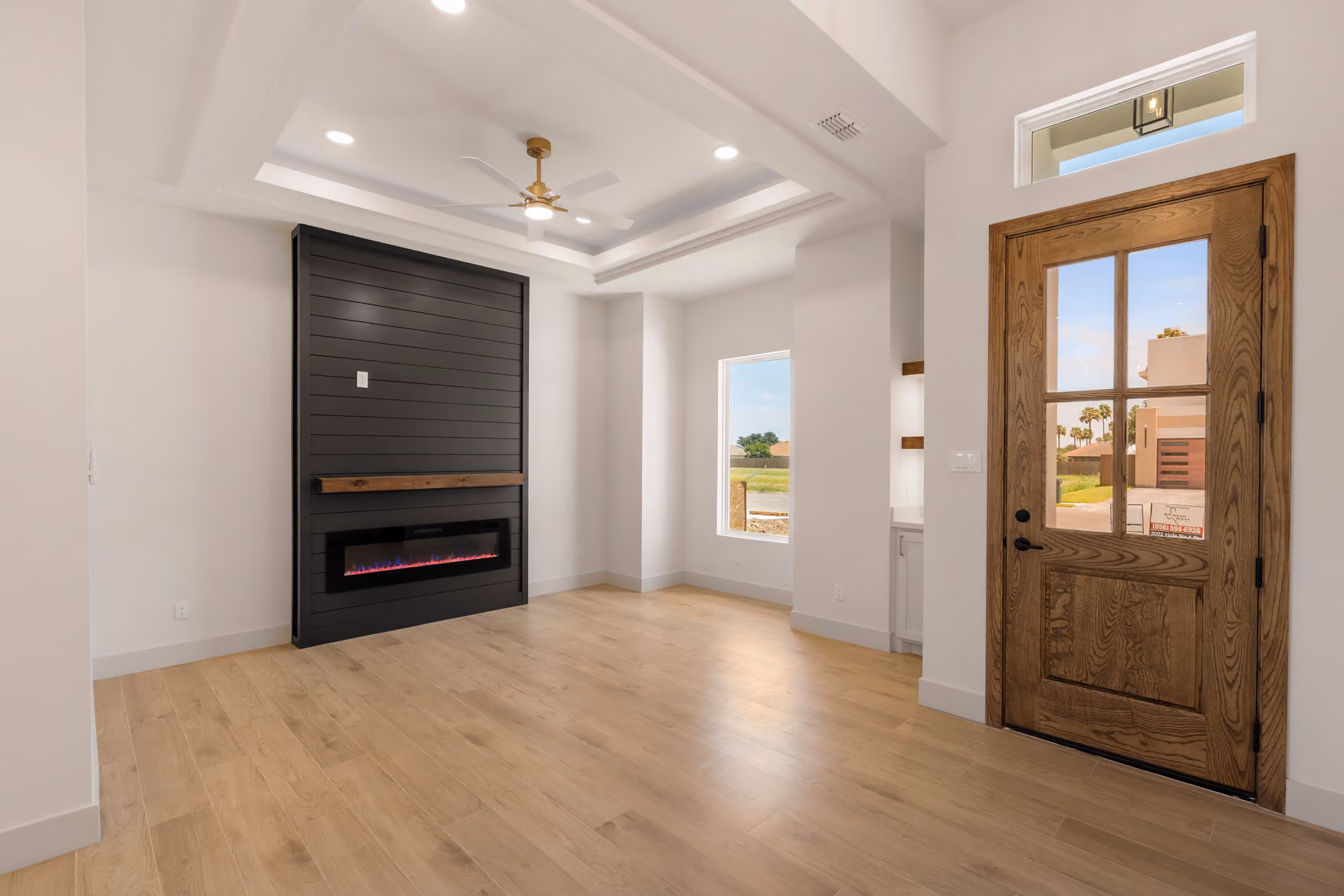 Front entry with a solid wood door and sidelight washing the foyer in daylight