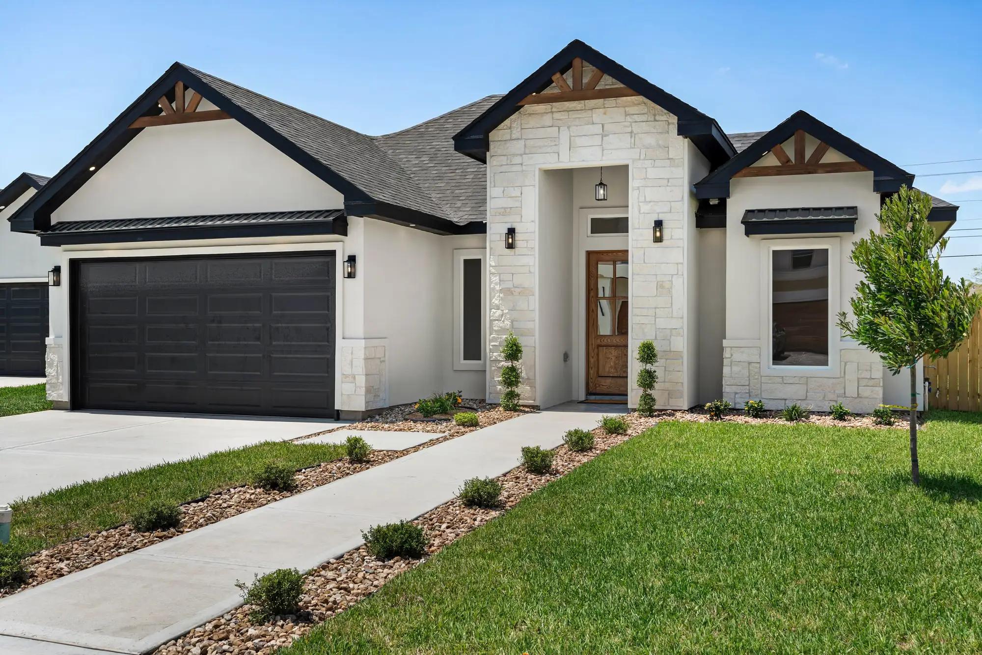 Close view of the stone facade and covered entry porch at Laguna Oaks