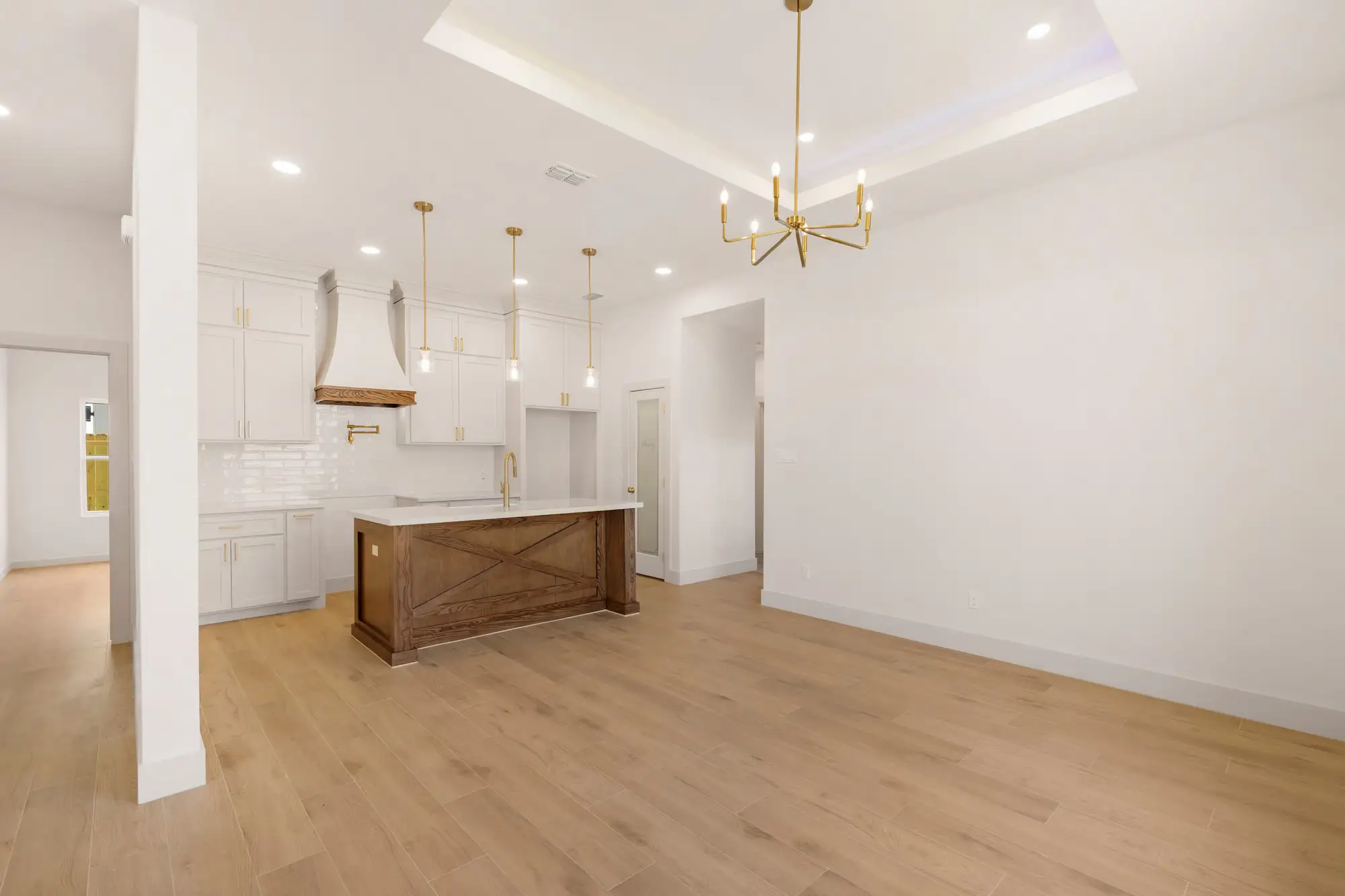 The kitchen seen from the living room, oak island anchoring the open plan
