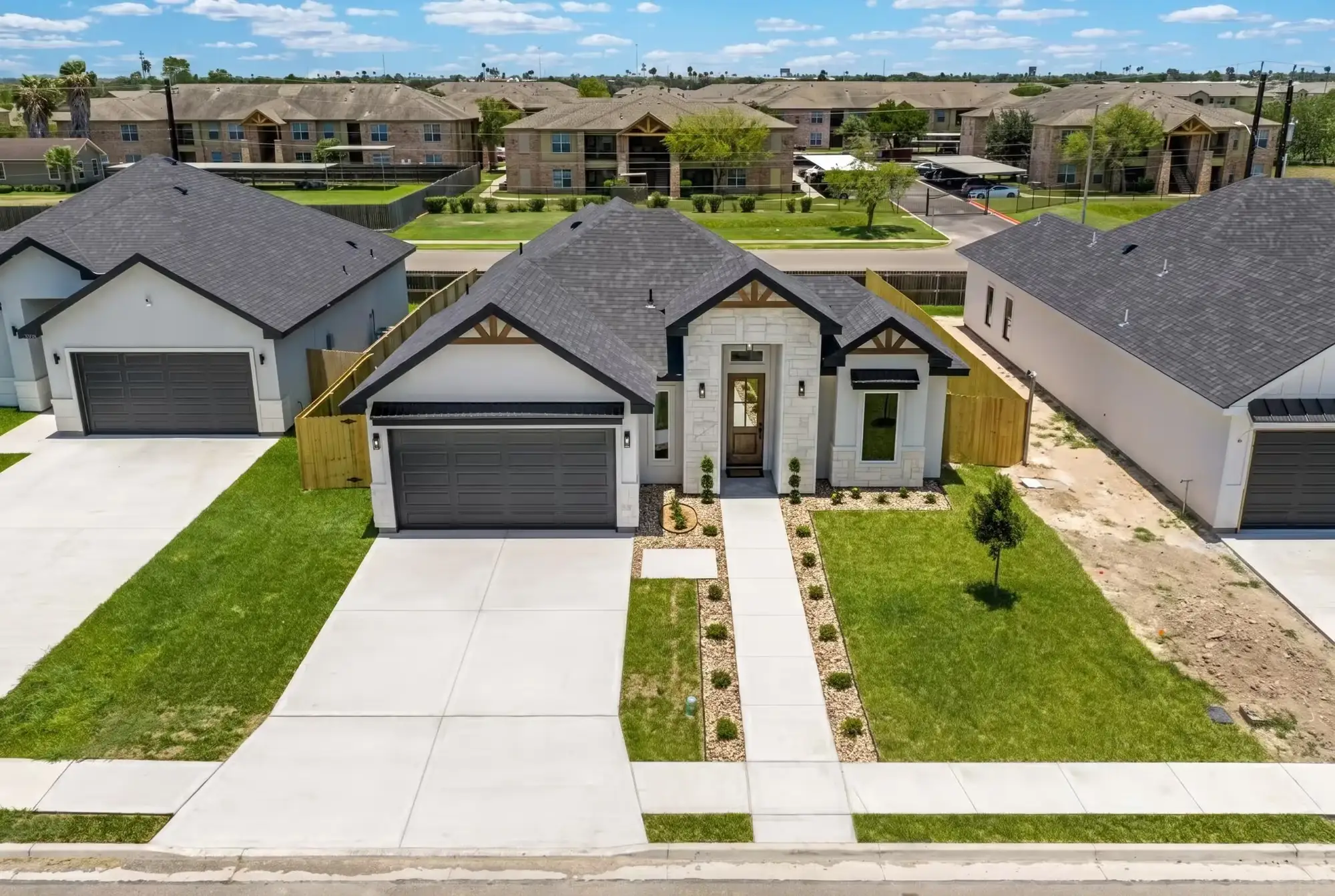 Street view of the Laguna Oaks home and its walkway leading past the two-car garage
