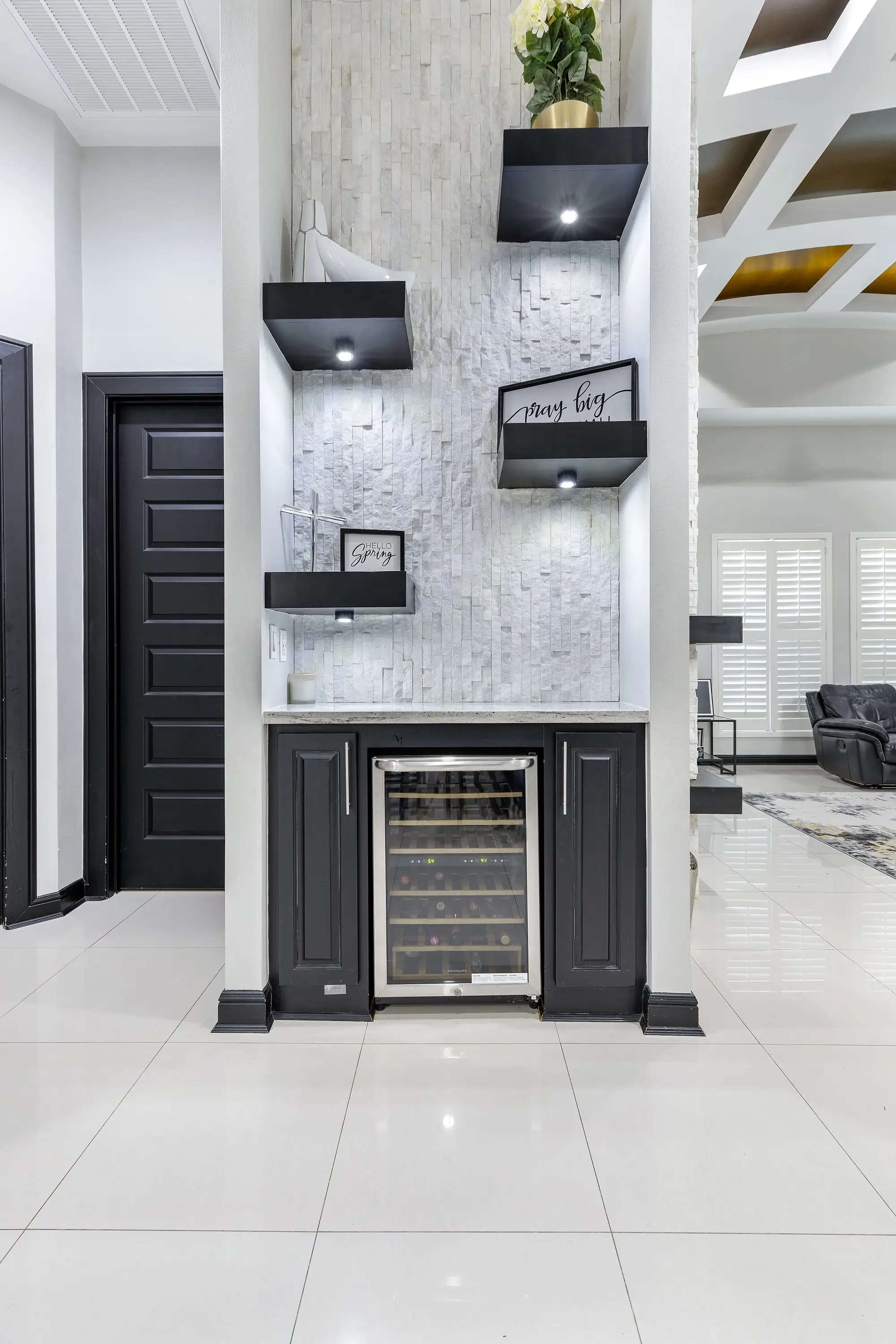 Marble fireplace wall with floating niches and an integrated wine display