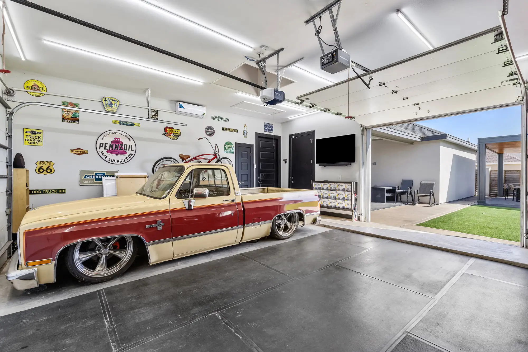 Garage finished as a showroom, with an epoxy floor and room for a collector truck