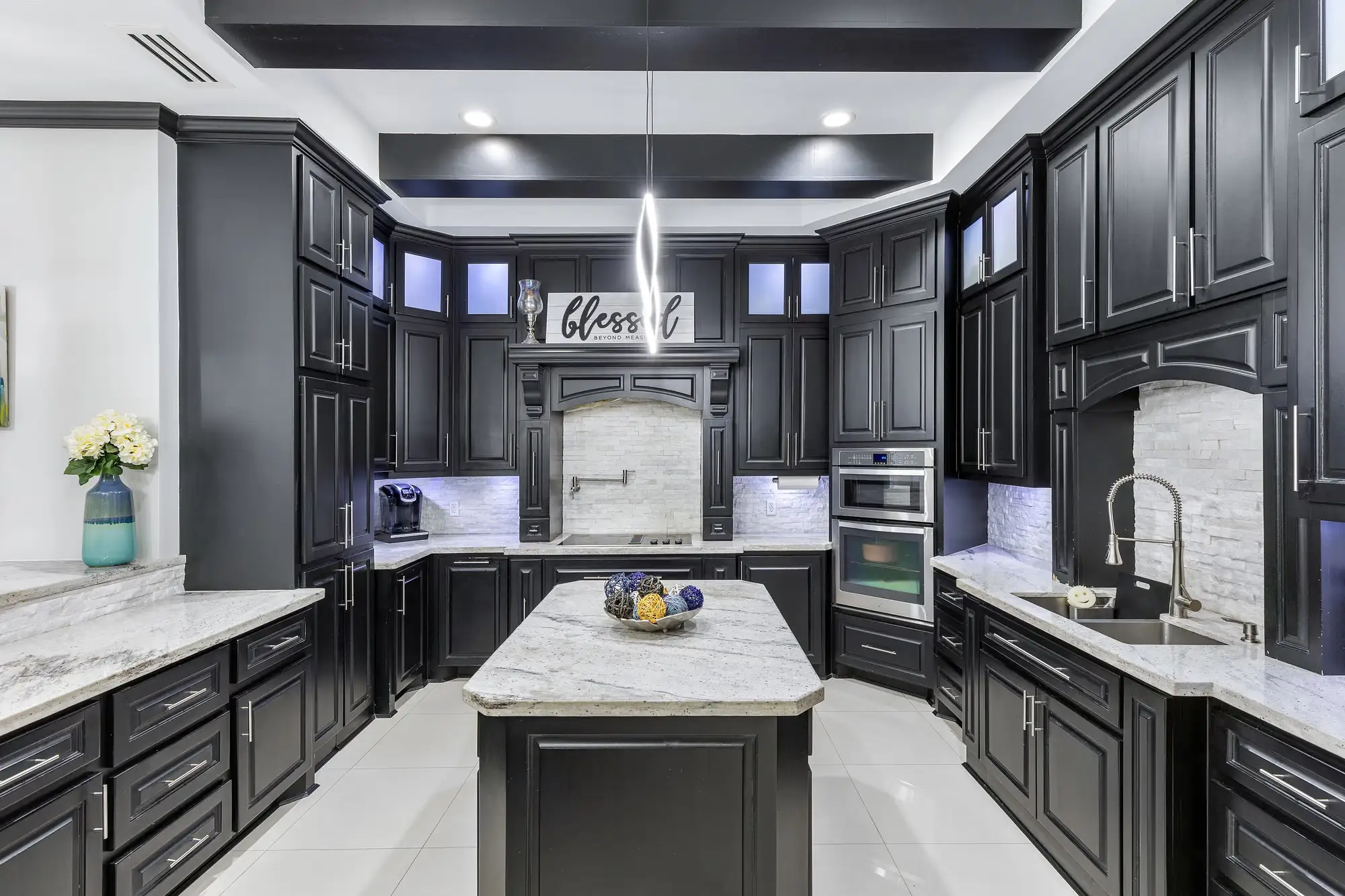 Kitchen detail: marble counters, double wall ovens and the pantry entry