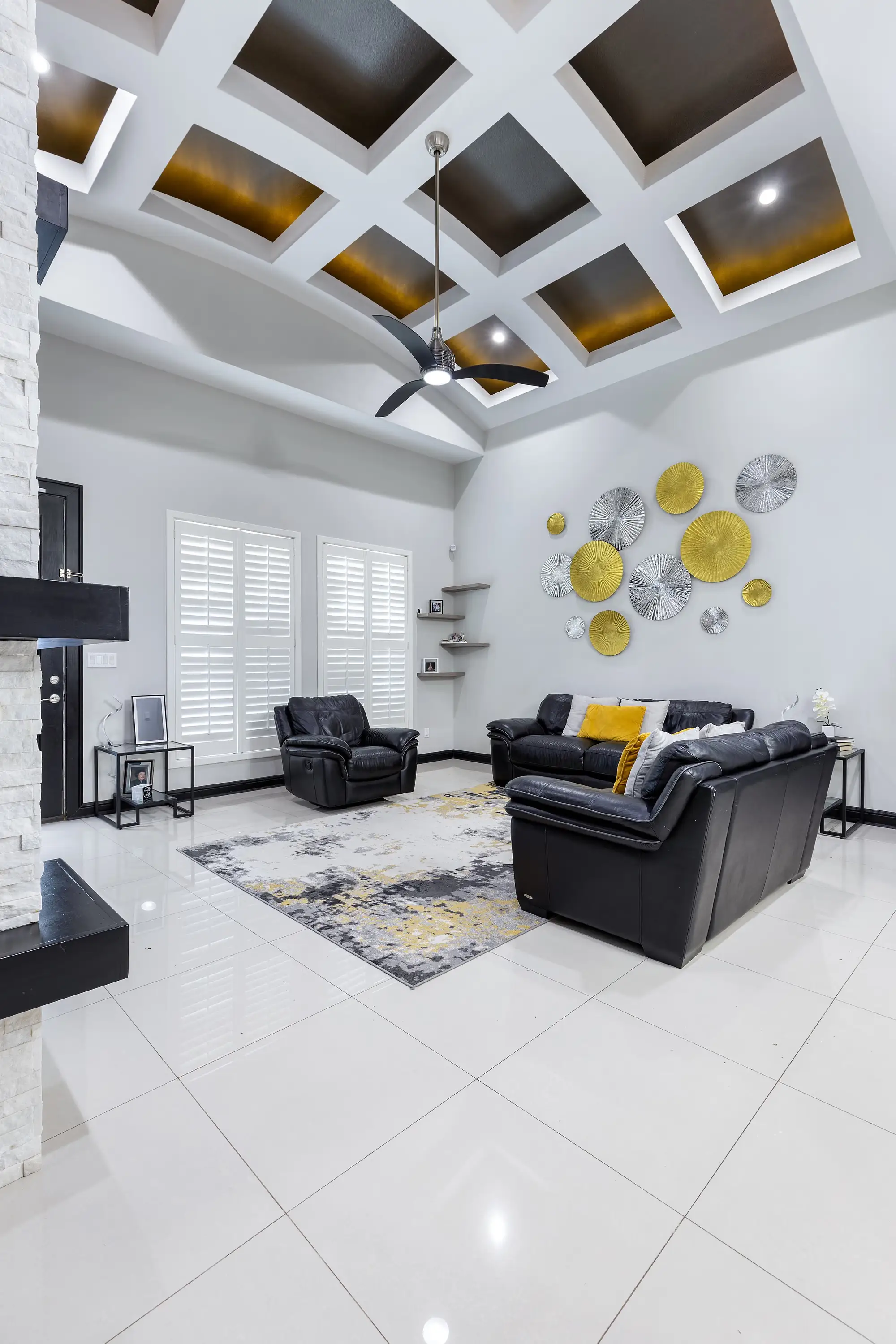 Family room with large-format porcelain floors and plantation shutters