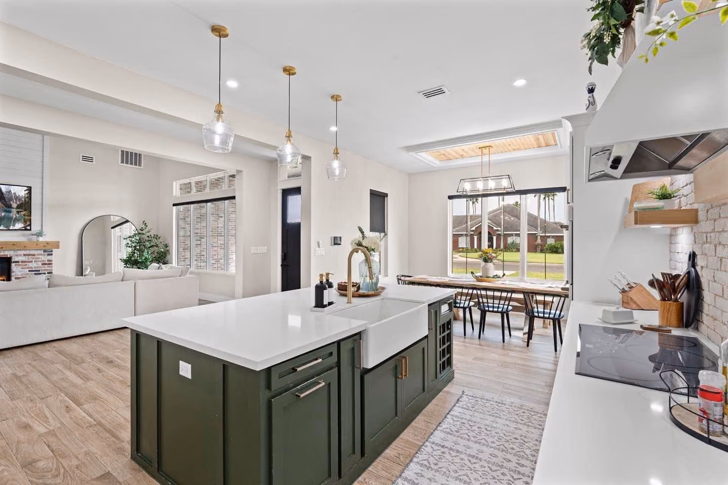 Kitchen open to the dining room under a wood-planked ceiling