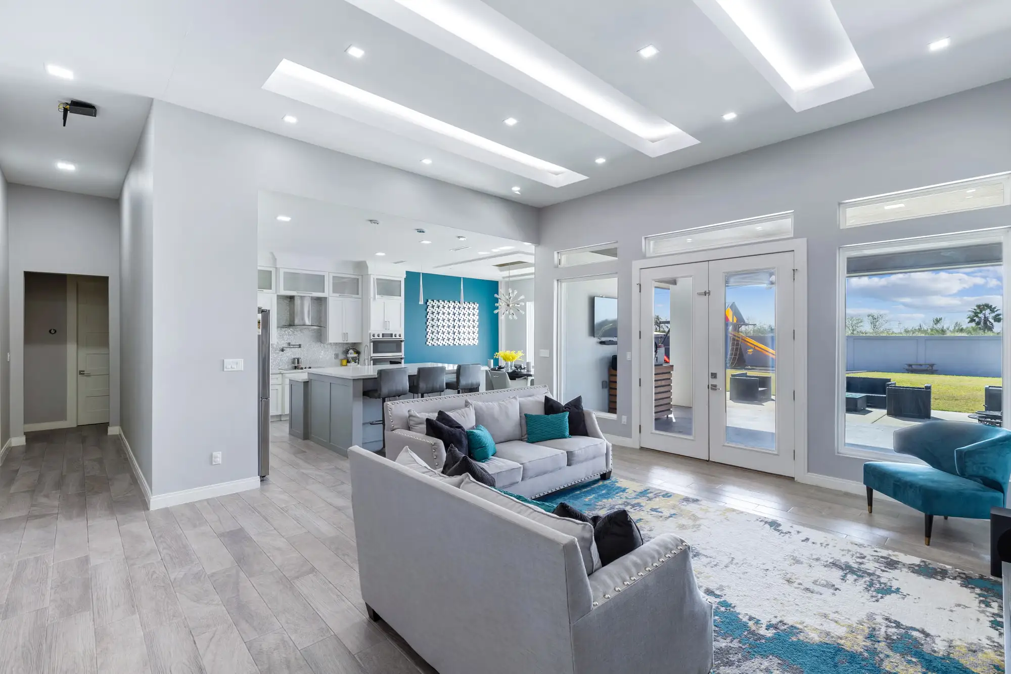 Living and kitchen in one open plan with paired French doors to the yard