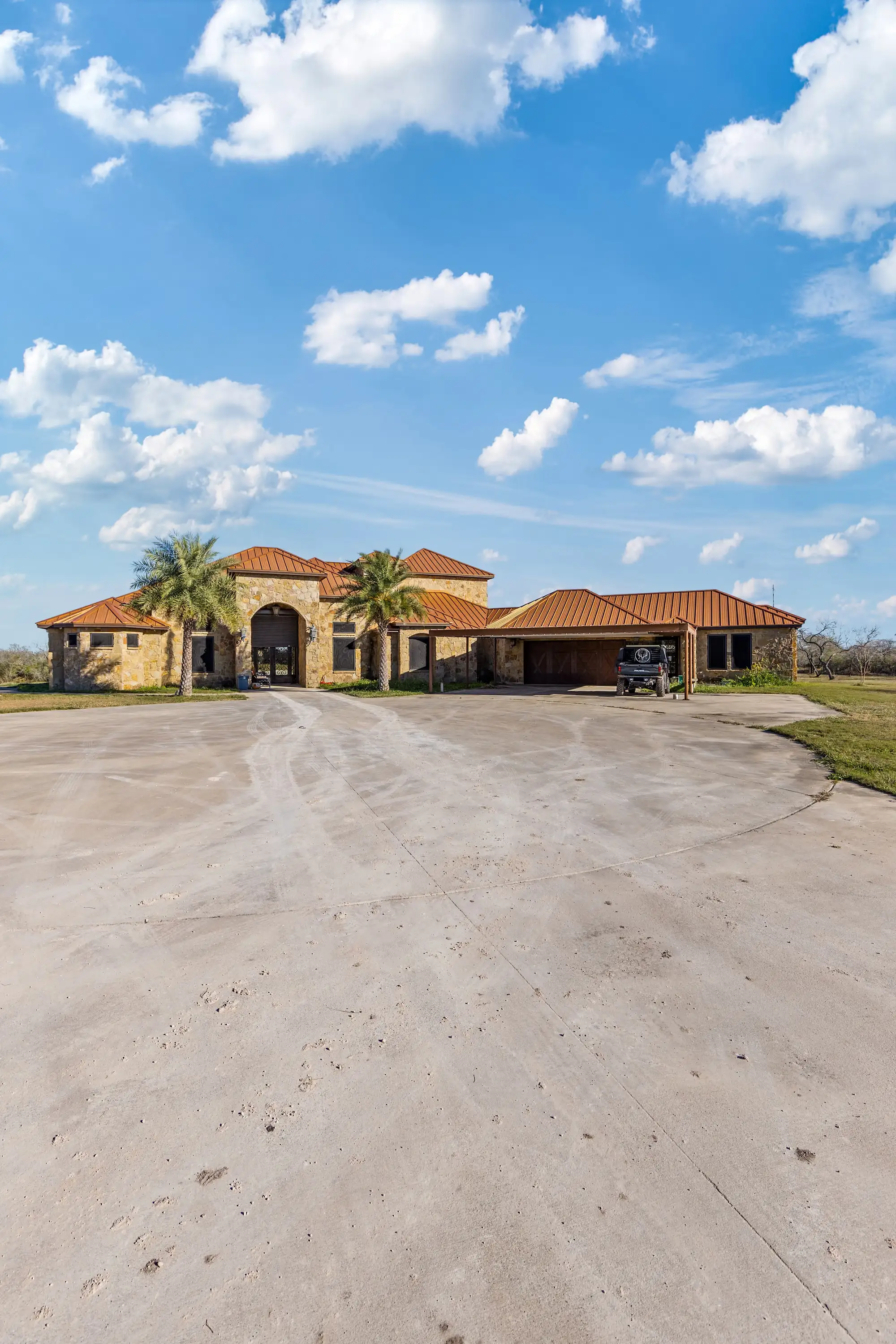 Full ranch-style elevation in clay tile and stone